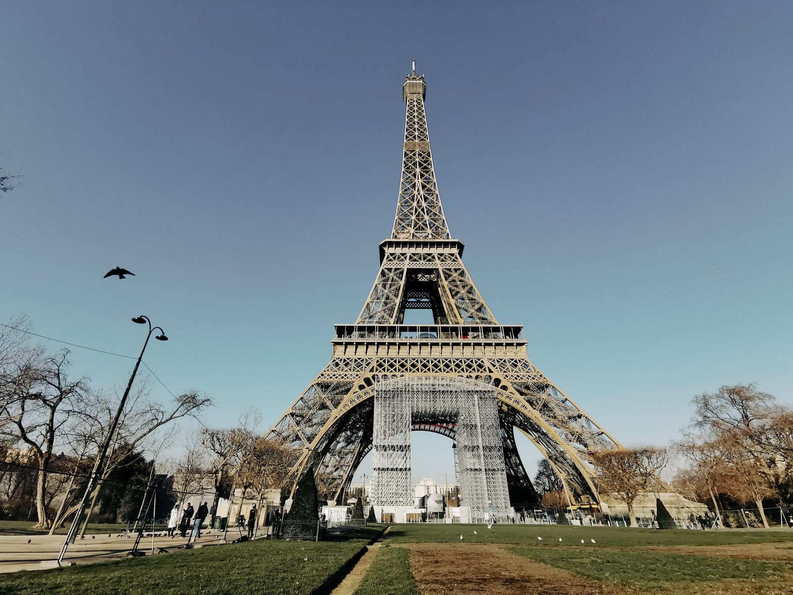 A stunning front view of the iconic Eiffel Tower in Paris with clear blue skies.